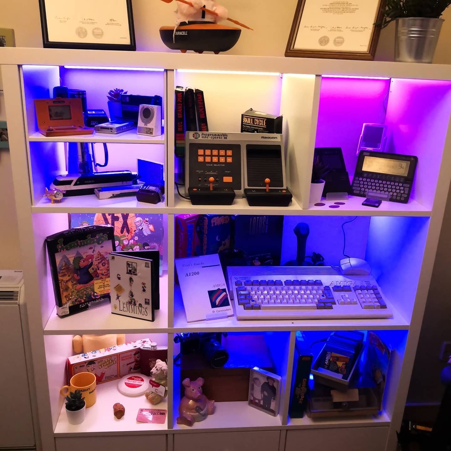 An IKEA Kallax display unit filled with retro tech and things that are special to me.